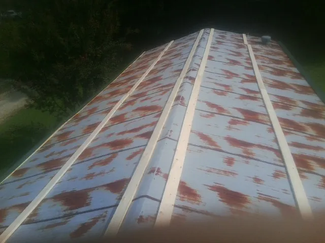 Rusted metal roof panels with new wood purlins before replacement — Storm Damage Roof Repair in Rhinebeck by Roofing Brothers