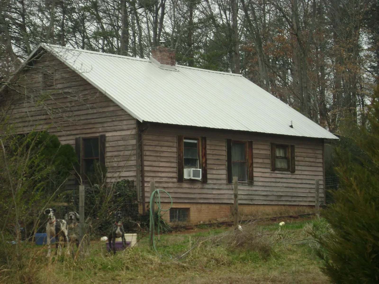 White metal roof on an old wood sided farmhouse, from a Metal Roof Installation job in Rhinebeck